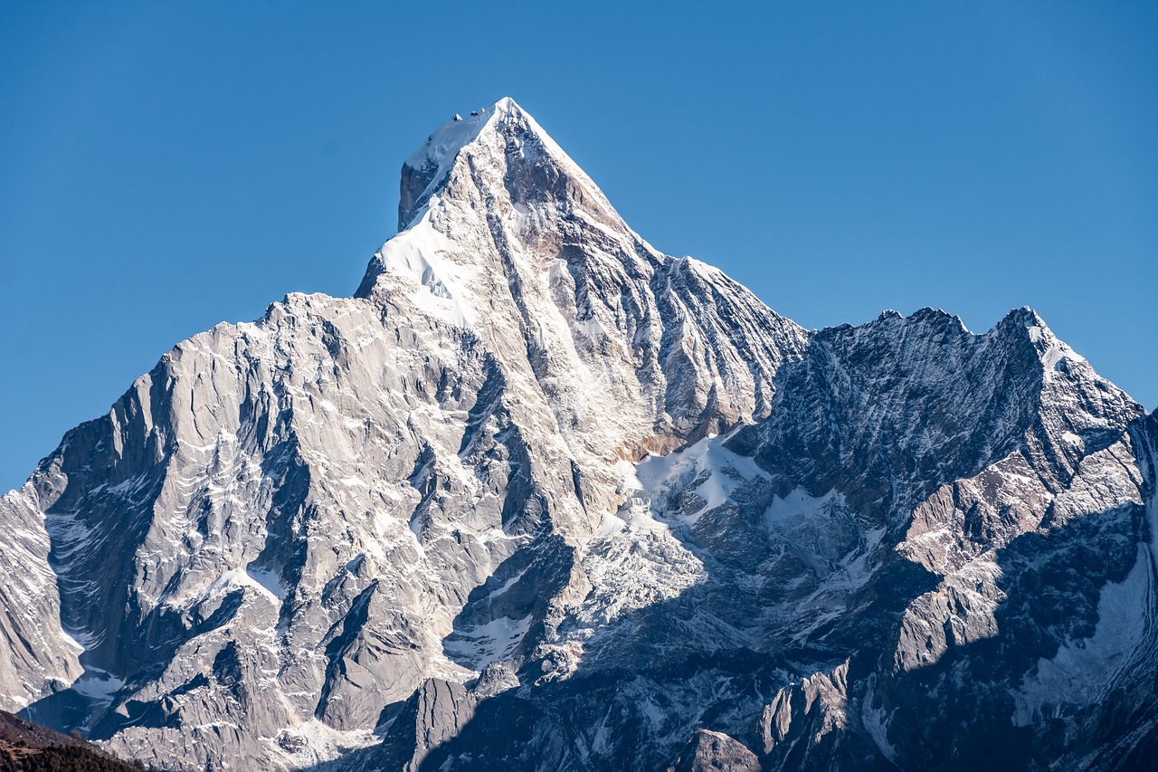 image of a craggy mountain against a blue sky
