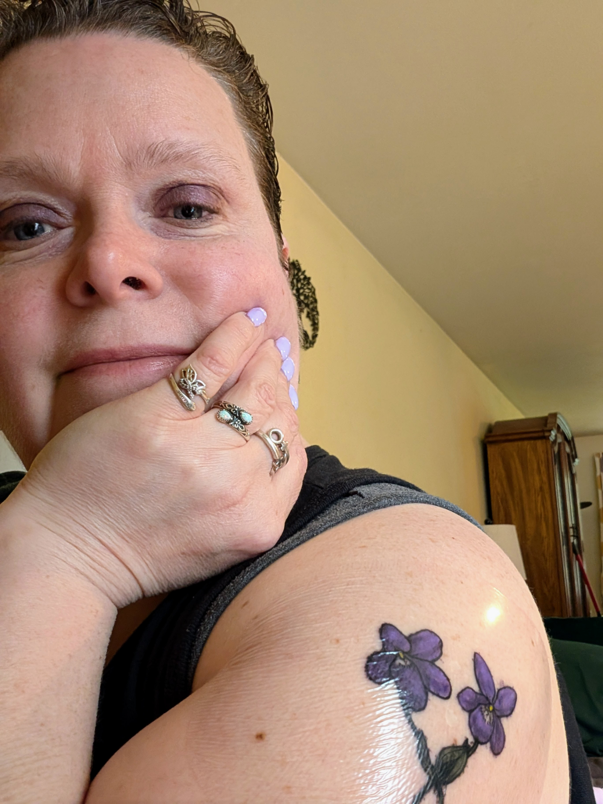 Elizabeth, CEO & Publisher of The Revealed Story Press, a lesbian-owned publishing house, showcasing her aesthetic and her violet tattoo. Her goal is to produce creative writing and support organizations focused on women, women's issues, radical feminism and lesbian visibility.